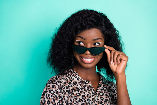 cheerful lady look empty space white smile wear specs leopard print shirt