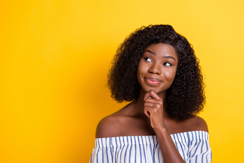 Close-up portrait of attractive curious girl creating new solution copy space isolated over bright yellow color background