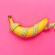 Yellow ripe banana wrapped in tape measure