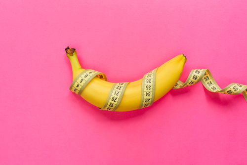Yellow ripe banana wrapped in tape measure