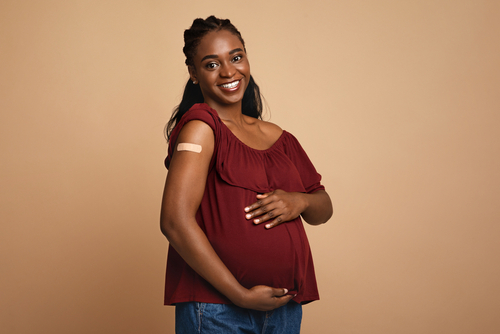 pregnant woman hugging her big tummy,