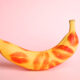 Fresh,Banana,With,Red,Lipstick,Marks,On,Pink,Background.,Oral