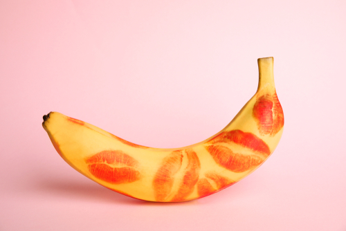 Fresh,Banana,With,Red,Lipstick,Marks,On,Pink,Background.,Oral